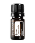 A small amber glass bottle of doTERRA Roman Chamomile essential oil with a black ribbed cap and a white label, centered on a plain white background.